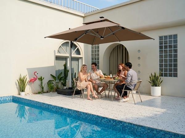 Cantilever umbrella beside an outdoor dining area with a wide weighted base
