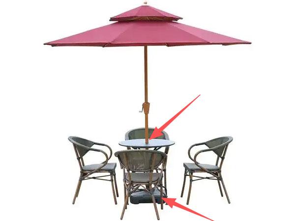 Center-pole umbrella passing through a patio table with a base beneath it