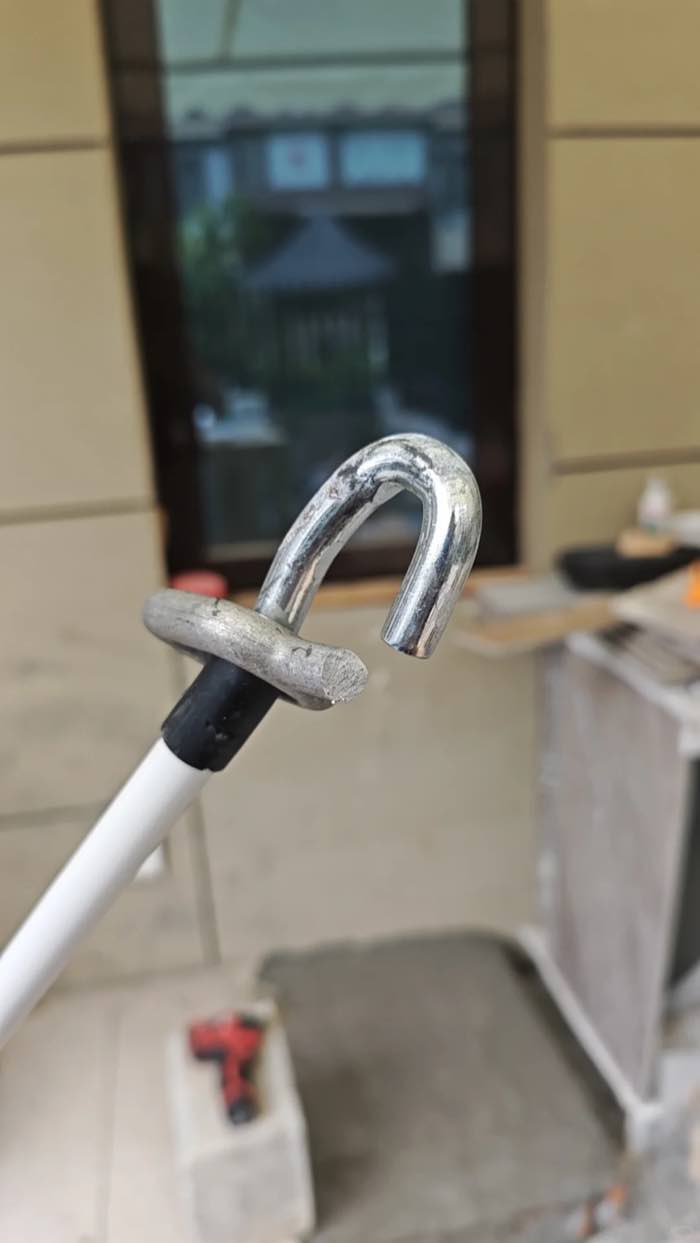 Broken metal hook on a manual awning crank handle